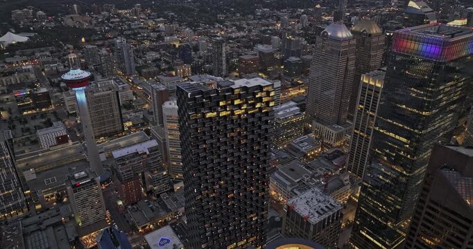 Calgary AB Canada Aerial v65 cinematic birds eye view drone flyover Downtown Commercial district capturing illuminated Beltline cityscape and sunset dusk sky - Shot with Mavic 3 Pro Cine - July 2023