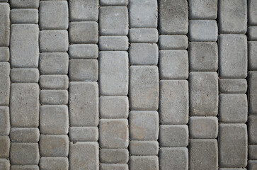Concrete blocks arranged in a pattern on a walkway in an outdoor area during daylight © mira_y