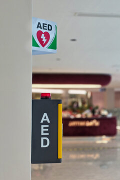 AED or Automated external defibrillator for heart attack first aid made available in public shopping center strategic location for emergency use. Attached to a wall, it can be easily reached.