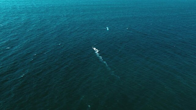 Aerial View of Open Pacific Ocean in Ecuador with Small Boat Wake, Deep Blue Water Texture and Minimal Tropical Seascape Background