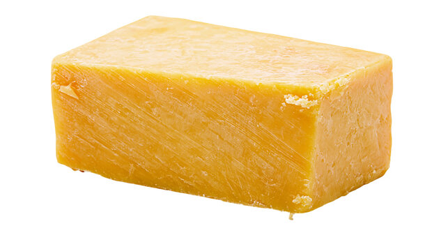 Solid block of aged cheddar cheese textured and yellow, isolated on transparent background