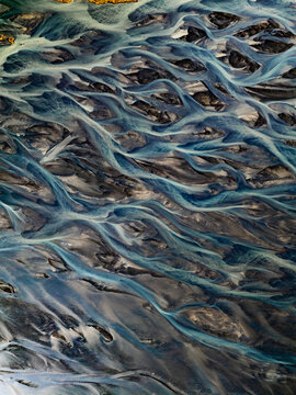 Aerial view of the intricate braided river patterns of a glacial delta in Iceland.