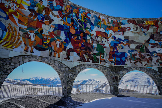 Russia-Georgia Friendship Monument mosaic at Jvari Pass with snowy Caucasus Mountains backdrop, Gudauri, Georgia