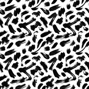 Seamless pattern of black ink brush strokes on white background