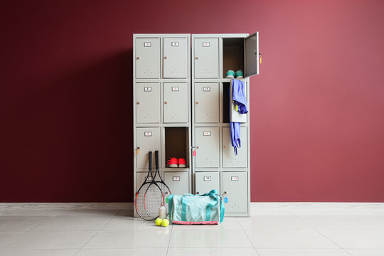Sports locker room with open lockers and tennis equipment