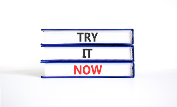 Try it now words symbol. Concept words Try is now on beautiful books. Beautiful white background. Business support motivational and try is now concept. Copy space.
