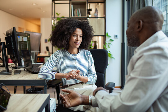 Man and woman coworkers in a one-on-one meeting at modern office