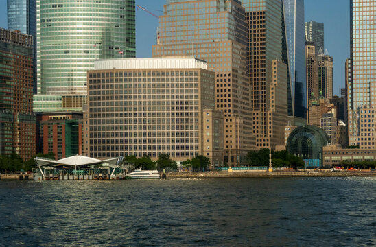 New York, NY - US - Jul 1, 2026 A skyline view of Lower Manhattan from the water, featuring prominent skyscrapers like Brookfield Place and the One World Trade Center near the Hudson River shoreline.