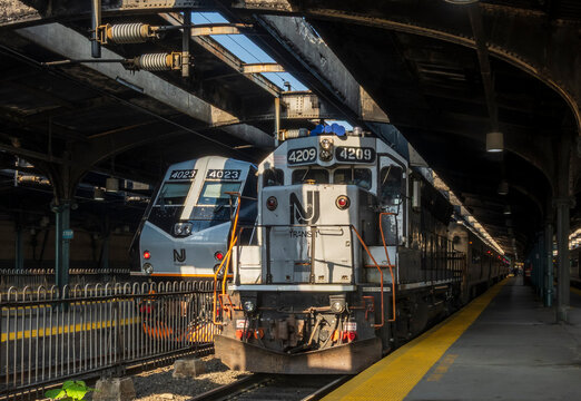 Hoboken, NJ - US - Jul 1, 2026 NJ Transit locomotives 4209, an EMD GP40PH-2B, and 4023, an Alstom PL42AC, idle under the historic 1907 Beaux Arts train shed at Hoboken Terminal