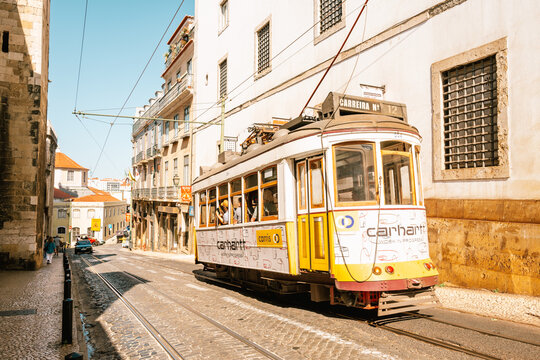 Lisbon, Portugal - July20, 2023: Yellow tram on narrow street