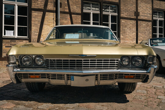 Berlin, Germany - May 3, 2026. Gold classic American car front view in Berlin.