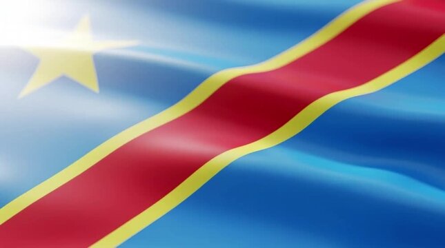 Close-up of the vibrant flag of the Democratic Republic of Congo waving in the sunlight, showcasing its blue, red, and yellow colors with a prominent star.