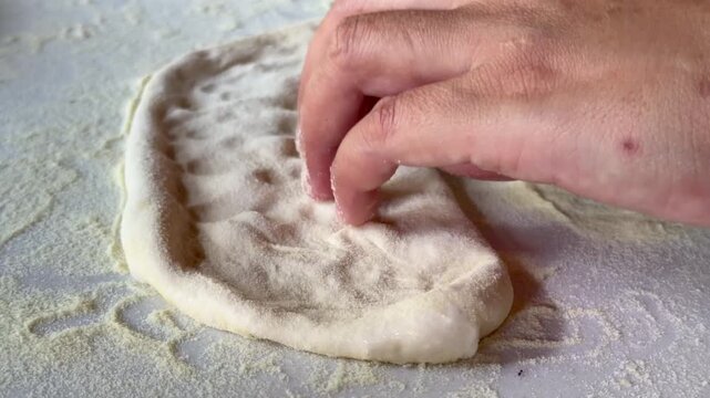 Preparation homemade pizza on kitchen table