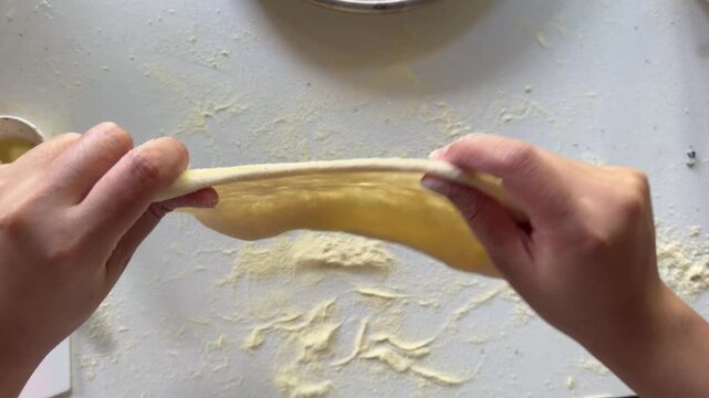 Preparation homemade pizza on kitchen table