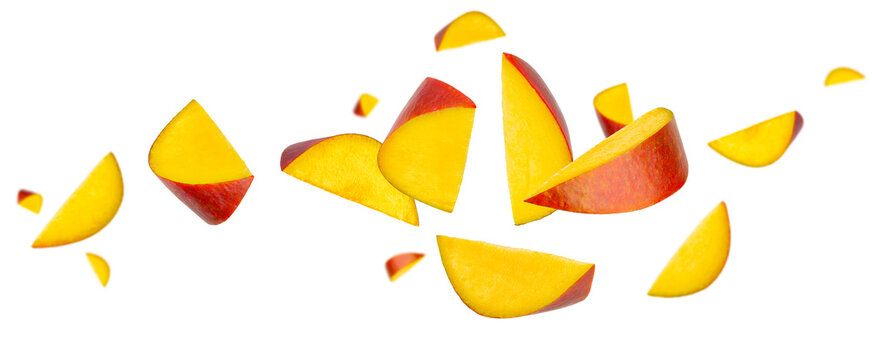 Beautifully retouched, longitudinally sliced mango pieces fly and levitate in space. Isolated on white.