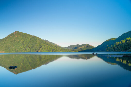 Crescent Lake, Olympica National Park scenic view with lake and mountains on a sunny clear day