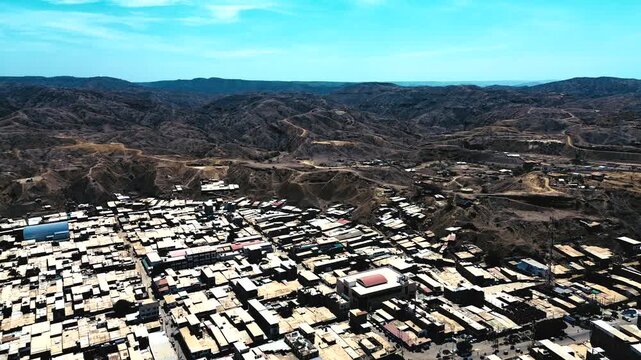 Aerial View of Ecuador Coastal City Edge with Dense Houses, Dry Hills, Rugged Landscape and Urban Expansion in South American Seaside Region