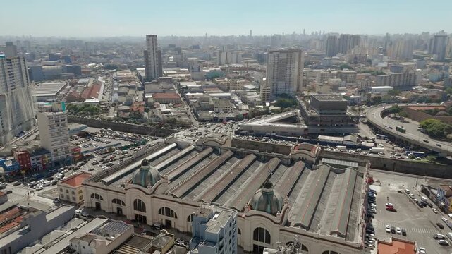 Aerial overflight of historic market domes and dense urban district in S&atilde;o Paulo. Overfly camera movement