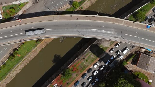 Aerial view of curved highway viaduct over Tamanduatei river in S&atilde;o Paulo. Static camera shot.