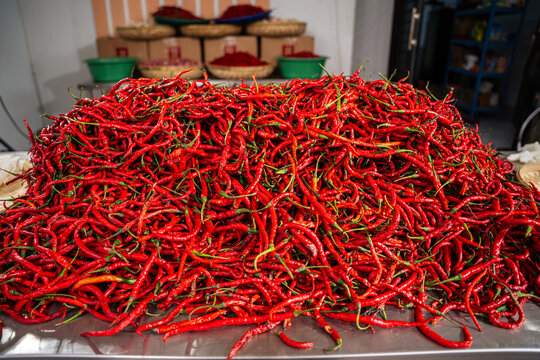 pile of Fresh Chilies and Ripe Red Chilies in Baskets for Sale at the Vegetable Market