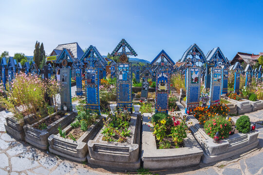 SAPANTA, MARAMURES, ROMANIA - SEPTEMBER 18, 2020: The Merry Cemetery, famous in the world for its colourful wood tombstones, with naive paintings describing the people who are buried there.