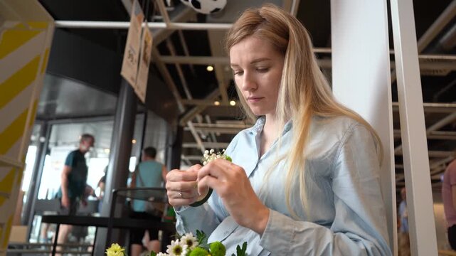 Woman making wildflower crown during floral workshop