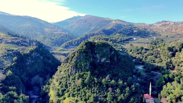 Drone view of Kurşunlu Manisa landscape with mountains forests flag and minaret in thermal tourism region
