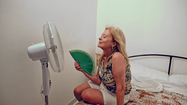 Older woman coping with summer heat