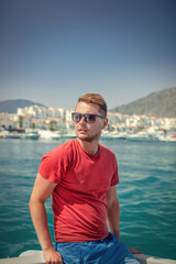 Fototapeta premium Man enjoying summer boat trip in harbor