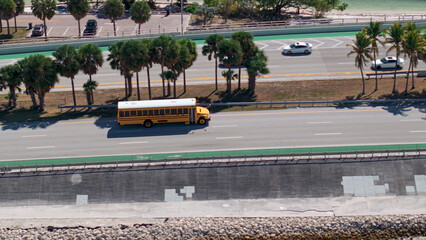 Yellow school bus driving on rickenbacker causeway highway © Chris M