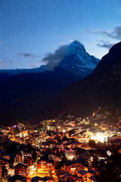Matterhorn mountain towering over zermatt village at night