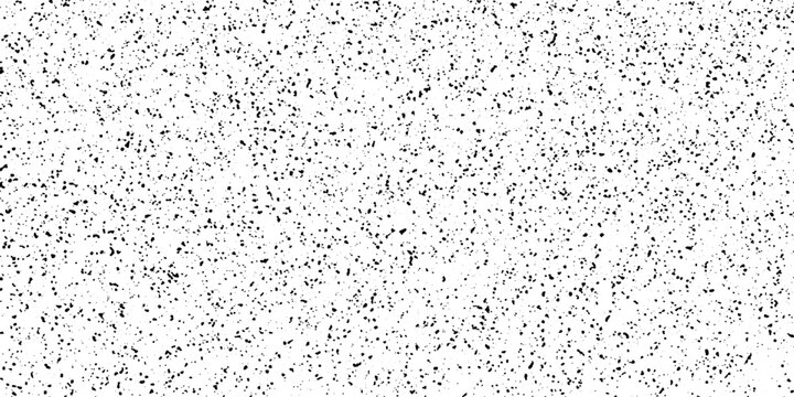 A subtle pattern of dark speckles scattered across a clean white surface, creating a minimalist and abstract texture.
