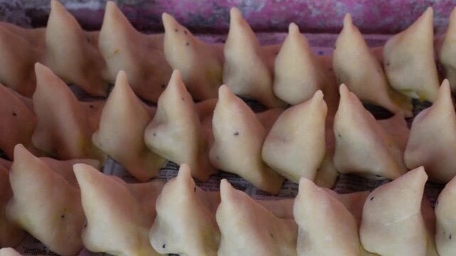 Fresh unfried samosas ready for frying