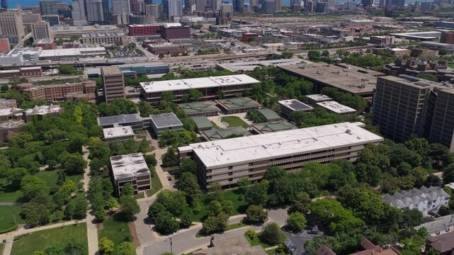 University of Illinois Chicago campus buildings surrounded by green trees in the Near West Side neighborhood, modern urban architecture and education