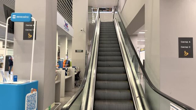 Parallel escalators inside a contemporary public interior with clean architectural design. Urban mobility, efficient transport, modern infrastructure, public access, daily commuting.