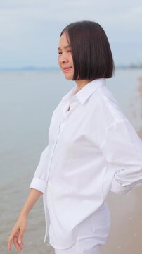 Woman walking barefoot along a peaceful beach