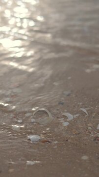 Gentle ocean waves washing onto a sandy beach, creating a peaceful and relaxing coastal background perfect for wellness, travel, and mindfulness concepts.