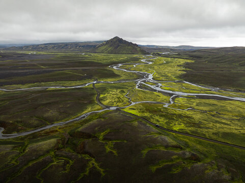 Aerial view of the moss-covered volcanic landscape and winding river system near Langisjor in Skaftarhreppur, Iceland.