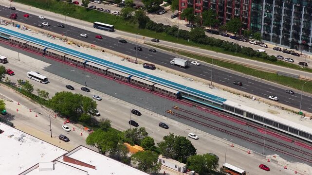 Elevated CTA L Train running alongside Dan Ryan Expressway traffic in Chicago, Illinois showing urban transportation, infrastructure, bustling city commute