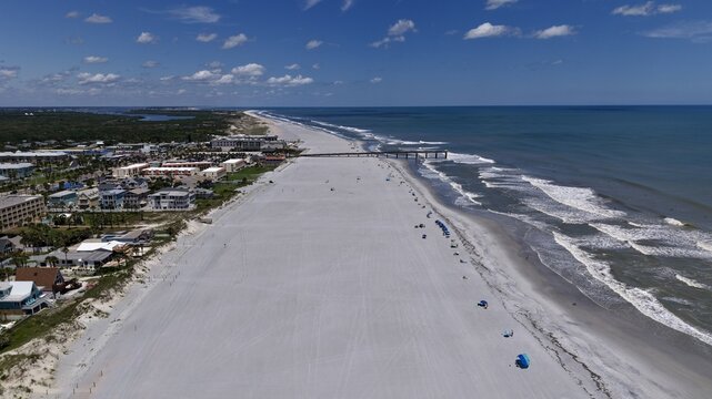 Aerial view of the sandy coastline and Atlantic Ocean waves along the beach in St. Augustine, Florida, United States.