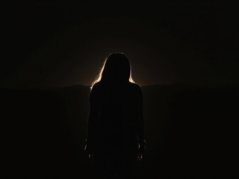 Silhouette woman dark backlight mystery shadow night alone moody dramatic female anonymous darkness outline contrast solitude backlit secret quiet calm quietness emotion suspense eerie glow