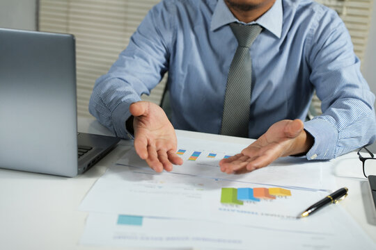 A leader, wearing an office shirt, is presenting a business idea to his business partner, client, sitting together, meeting with startup partners, talking, discussing and explaining strategies.