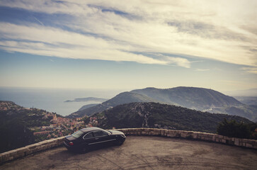Obraz premium Luxury car parked at eze village overlooking mediterranean sea