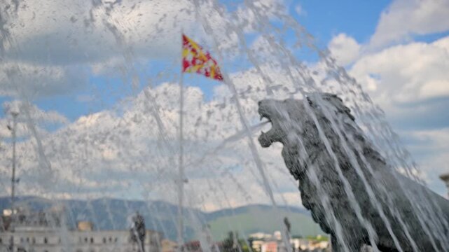 Water fountain with lion sculpture and Macedonian flag in Skopje
