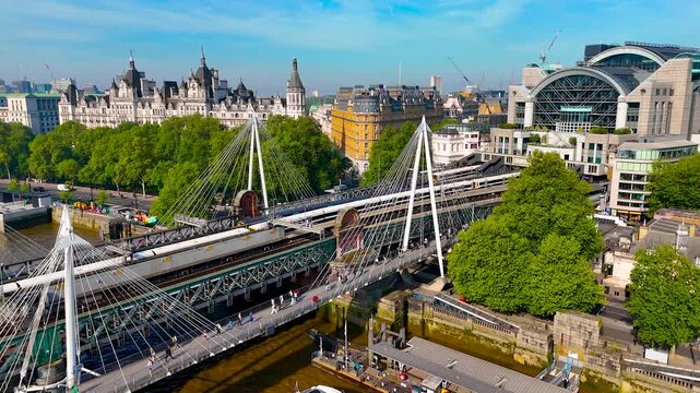 Drone image of Charing Cross Station in London, highlighting its modern arched design, train tracks, and prime urban location. Great for transport, travel, and infrastructure themes