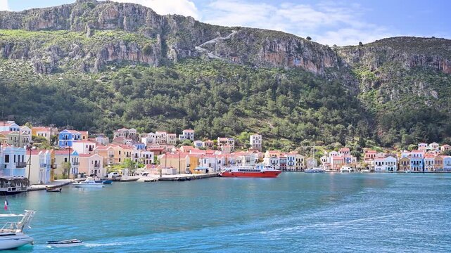 Sailboat leaving Kastellorizo's scenic harbor in Greece