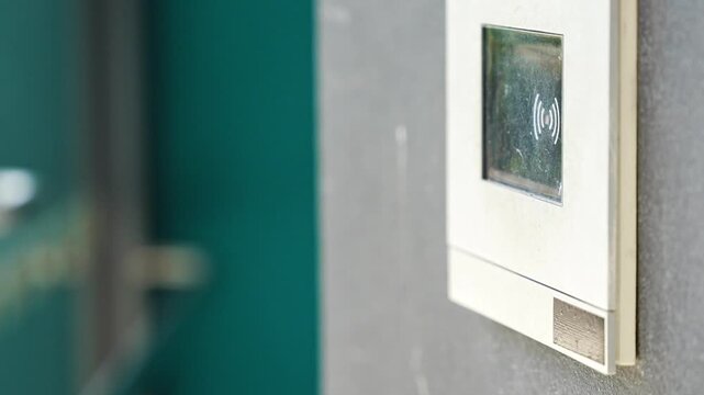 Modern apartment building intercom with keypad and contactless access system. Secure residential access highlights smart building technology and everyday home security.