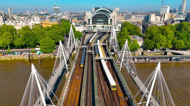 Drone image of Charing Cross Station in London, highlighting its modern arched design, train tracks, and prime urban location. Great for transport, travel, and infrastructure themes