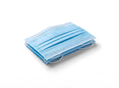 Stack of blue disposable face masks with ear loops isolated on white background