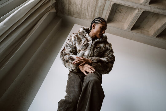Dancer Moves in Furry Coat Indoors Under Natural Light